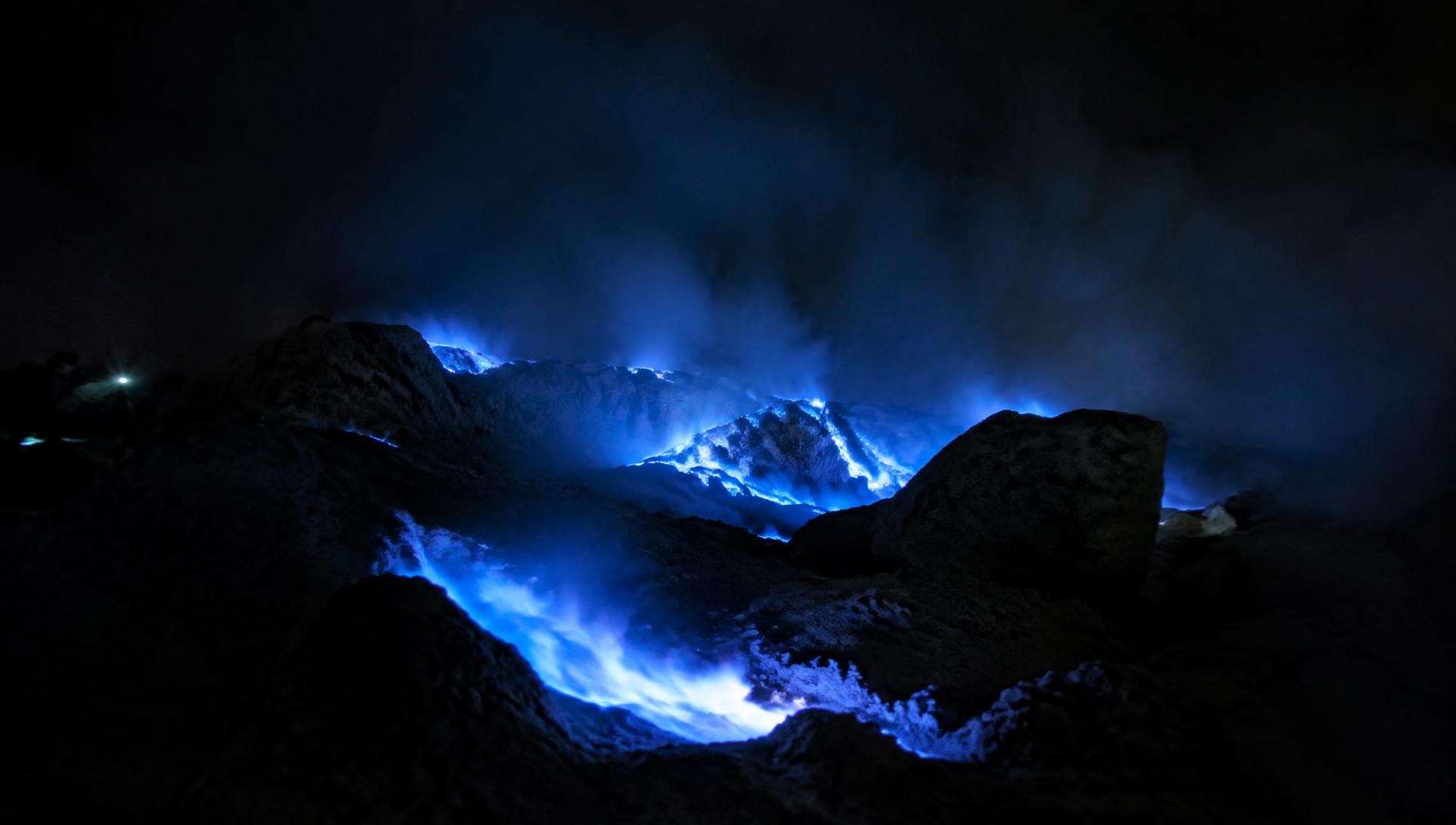 Blue fire burning inside Ijen crater at night