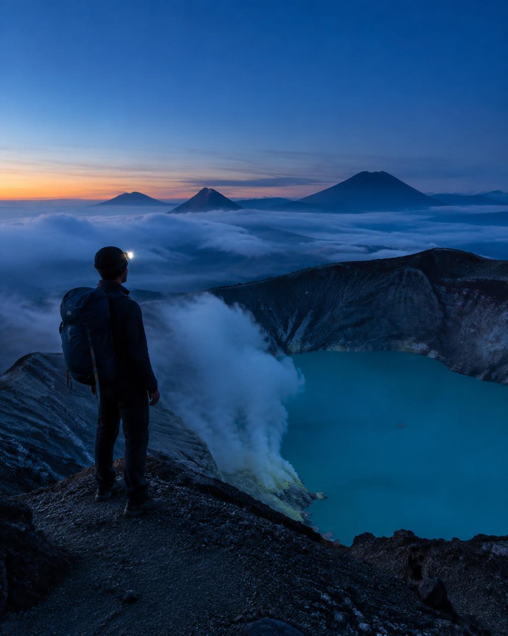 Hiker on the Ijen crater rim before sunrise